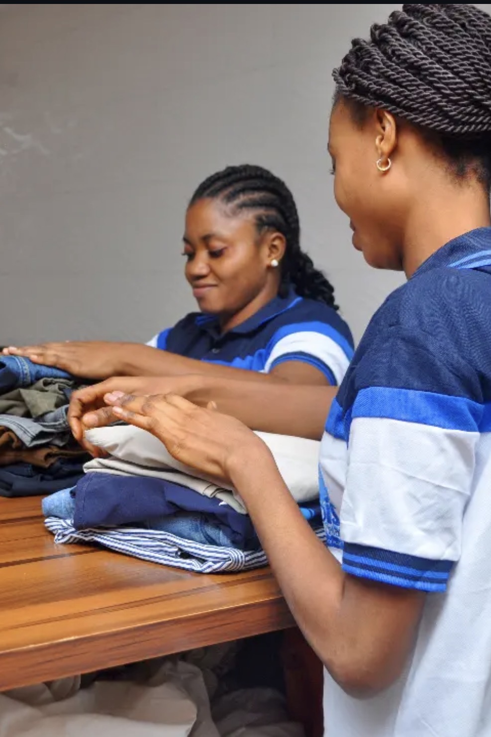 JOKBIS Laundromat staff carefully folding clothes